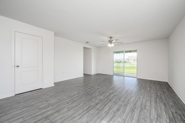 unfurnished room with a ceiling fan, a textured ceiling, and wood finished floors