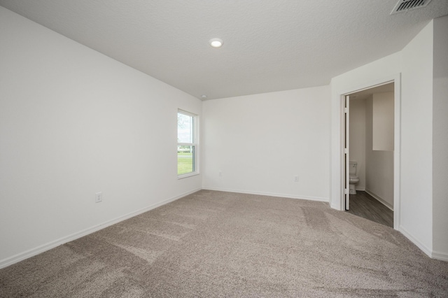 interior space with visible vents, a textured ceiling, and baseboards