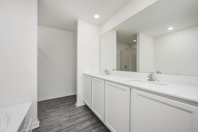 bathroom featuring vanity, shower with separate bathtub, and hardwood / wood-style flooring