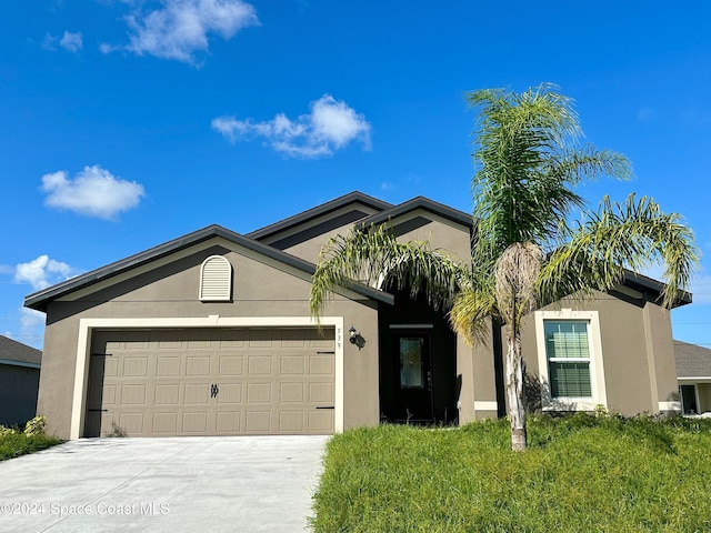 single story home featuring driveway, a garage, and stucco siding