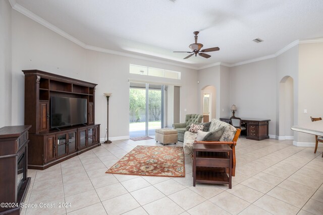 living room featuring ceiling fan, ornamental molding, and light tile patterned floors