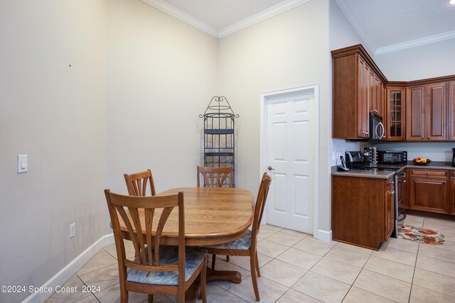 tiled dining area featuring ornamental molding