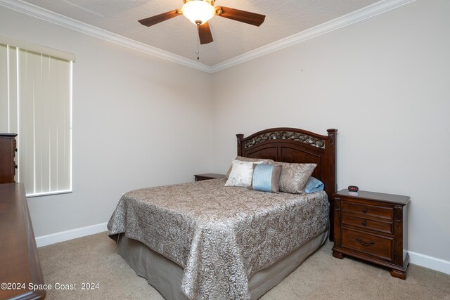 bedroom featuring a textured ceiling, light colored carpet, ceiling fan, and crown molding