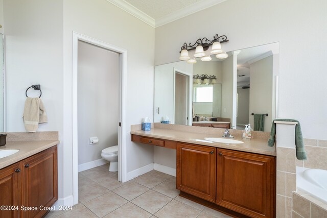 bathroom featuring toilet, tile patterned floors, ornamental molding, vanity, and tiled bath