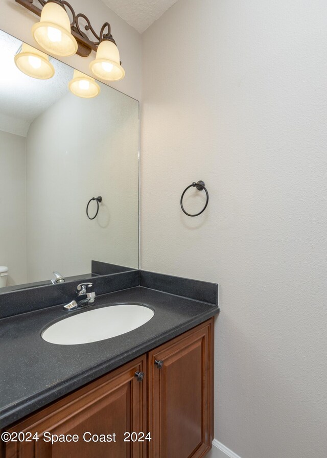 bathroom with a textured ceiling and vanity