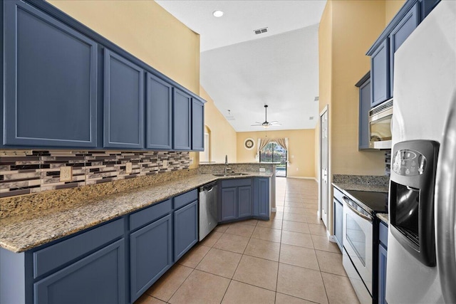 kitchen featuring blue cabinets, a sink, stainless steel appliances, a peninsula, and light tile patterned floors