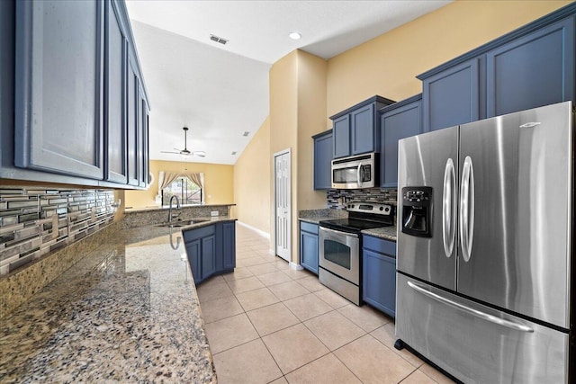 kitchen with light tile patterned floors, visible vents, stainless steel appliances, blue cabinets, and backsplash