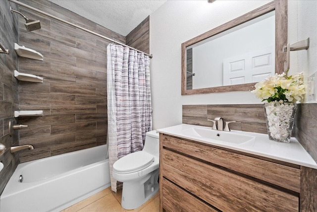 full bathroom with vanity, tile patterned flooring, shower / bath combination with curtain, a textured ceiling, and toilet