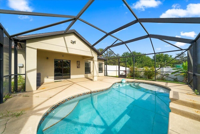 view of swimming pool with a fenced in pool, fence, a lanai, and a patio area