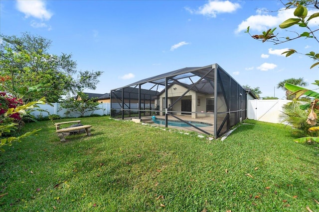 view of yard with glass enclosure, a fenced backyard, and a fenced in pool