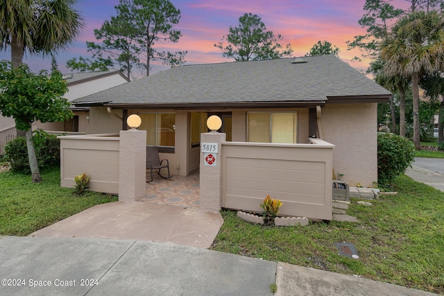 view of front of house with a yard