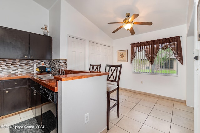 kitchen with tasteful backsplash, light tile patterned floors, sink, ceiling fan, and black dishwasher