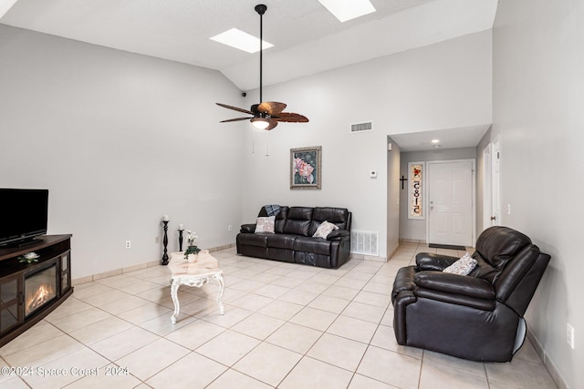 living area featuring a skylight, light tile patterned floors, and visible vents