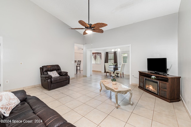 living room featuring ceiling fan, light tile patterned floors, and high vaulted ceiling