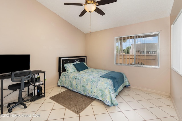 bedroom featuring lofted ceiling, ceiling fan, tile patterned flooring, and baseboards