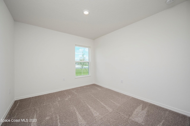 unfurnished room with carpet, baseboards, and recessed lighting