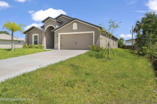 291 Gamewell Rd SW, Palm Bay, FL 32908 - single story home featuring stucco siding, a garage, driveway, and a front lawn