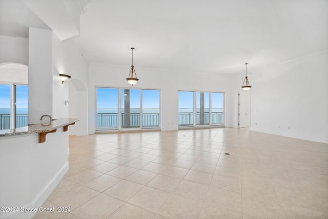 unfurnished living room with light tile patterned floors and baseboards