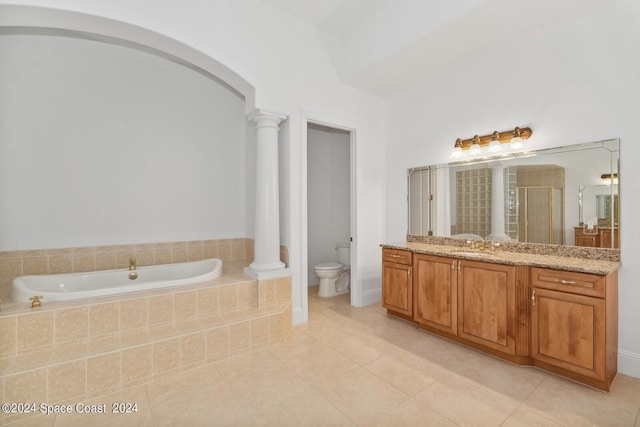 full bath featuring toilet, decorative columns, a stall shower, a bath, and vanity