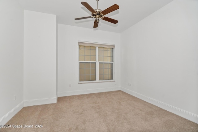 unfurnished room featuring carpet, baseboards, and ceiling fan