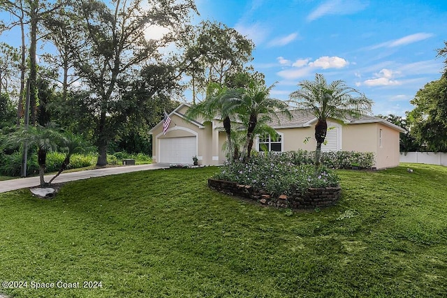 view of front of property with a front yard and a garage