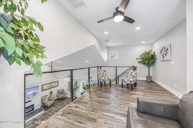 interior space featuring wood-type flooring and ceiling fan