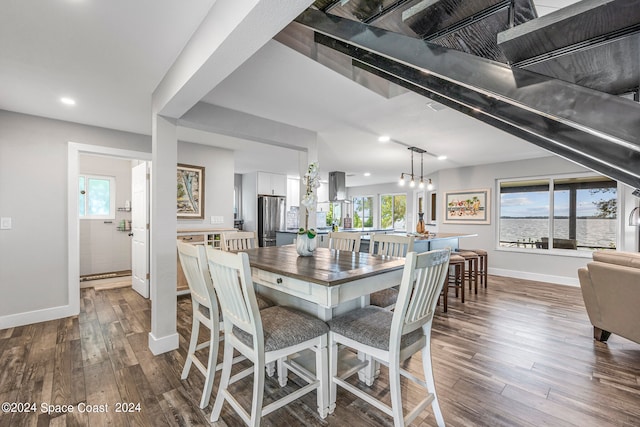 dining area featuring dark wood-type flooring and plenty of natural light