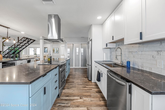 kitchen featuring a kitchen island, wood-type flooring, island range hood, stainless steel appliances, and sink