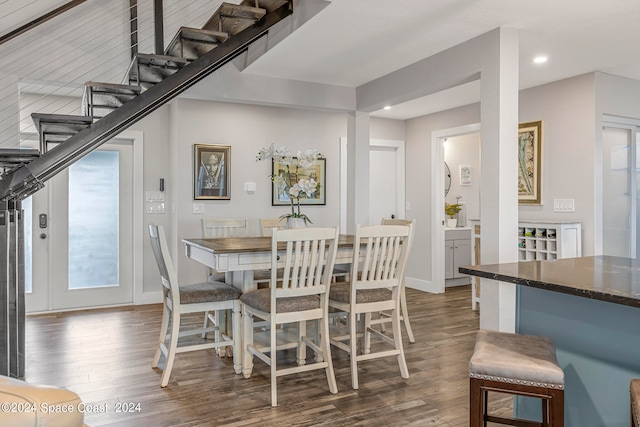 dining space with dark hardwood / wood-style flooring