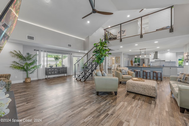 living room featuring ceiling fan, dark hardwood / wood-style floors, and high vaulted ceiling