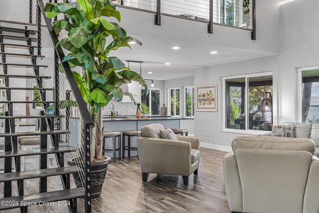 living room with a high ceiling and hardwood / wood-style flooring