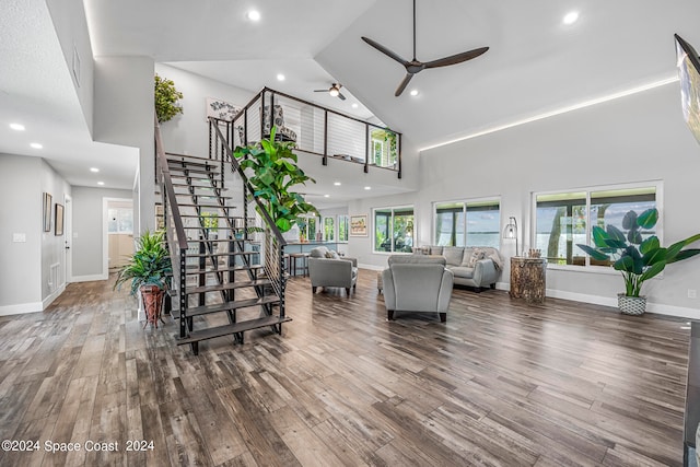 living room with high vaulted ceiling, dark hardwood / wood-style flooring, and ceiling fan