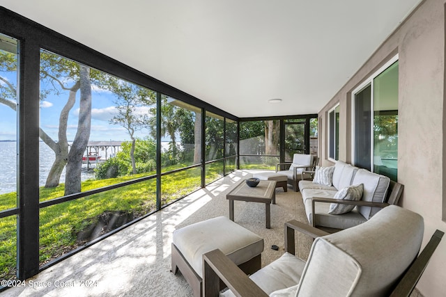 sunroom featuring a water view