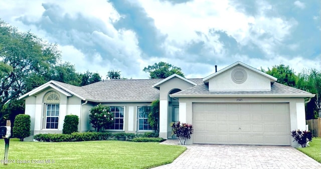 ranch-style home featuring a front yard and a garage