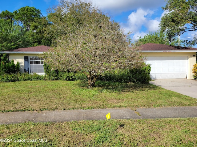 view of front of house with a garage and a front yard