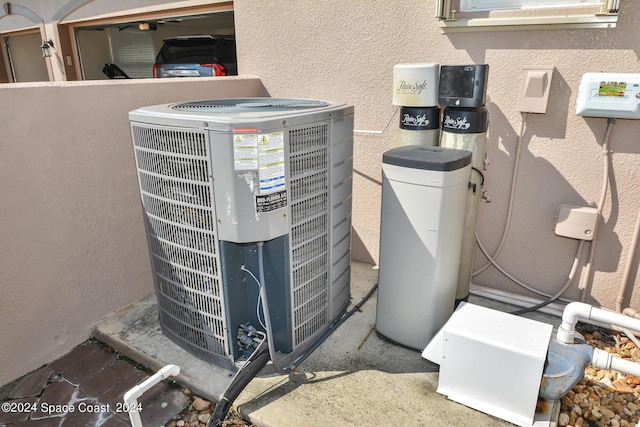 exterior details with stucco siding and central AC unit