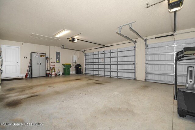 garage with a garage door opener and electric panel