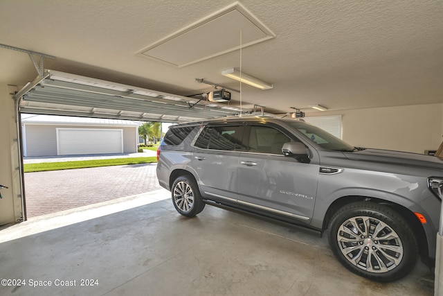 garage with a garage door opener and a carport