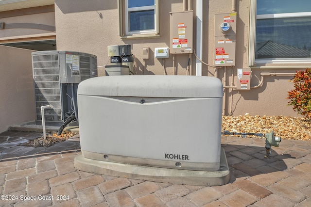 exterior details featuring a power unit, cooling unit, and stucco siding