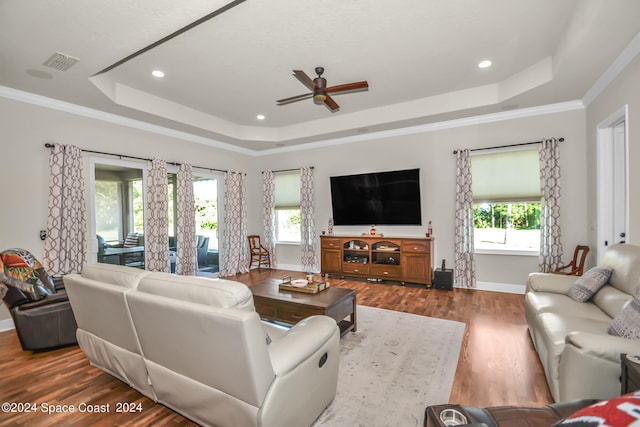 living room featuring plenty of natural light, ceiling fan, ornamental molding, and hardwood / wood-style flooring