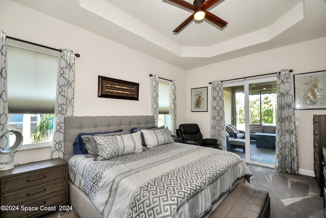 bedroom featuring access to exterior, ceiling fan, baseboards, and a raised ceiling