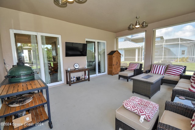 living room with carpet floors and an inviting chandelier