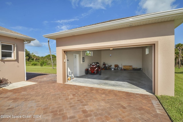 garage featuring decorative driveway