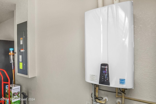 room details with water heater and a textured wall