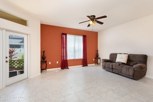 living room featuring a wealth of natural light, ceiling fan, and light tile patterned floors