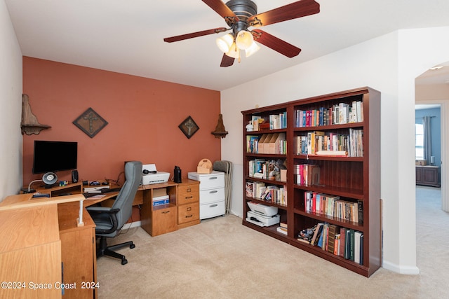 home office featuring ceiling fan and light colored carpet