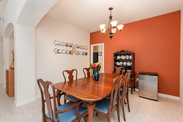 dining space featuring light tile patterned floors and an inviting chandelier