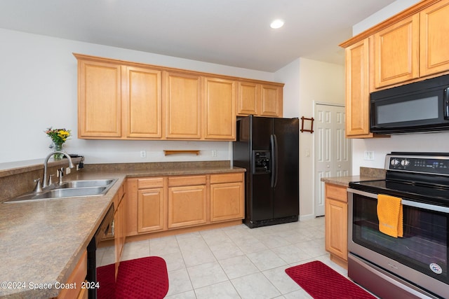 kitchen featuring light tile patterned floors, recessed lighting, a sink, black appliances, and dark countertops