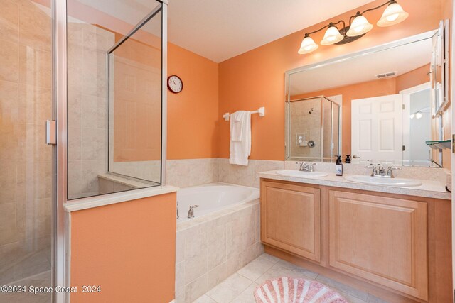 bathroom with vanity, shower with separate bathtub, and tile patterned floors