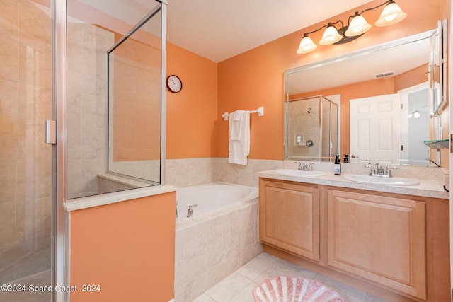 bathroom with tile patterned flooring, a sink, visible vents, a shower stall, and a bath